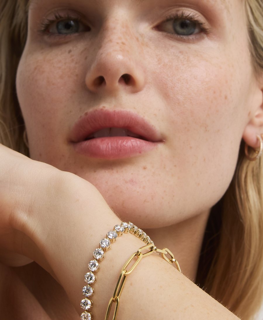 Model with diamond tennis and chain bracelets