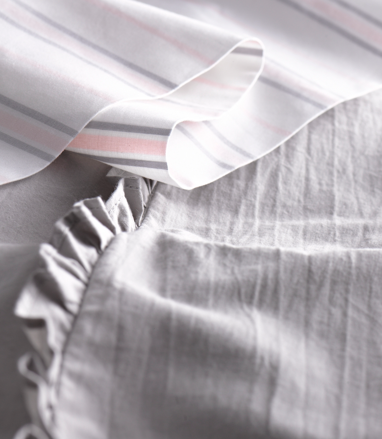 Pink and gray striped fabric swatch, folded