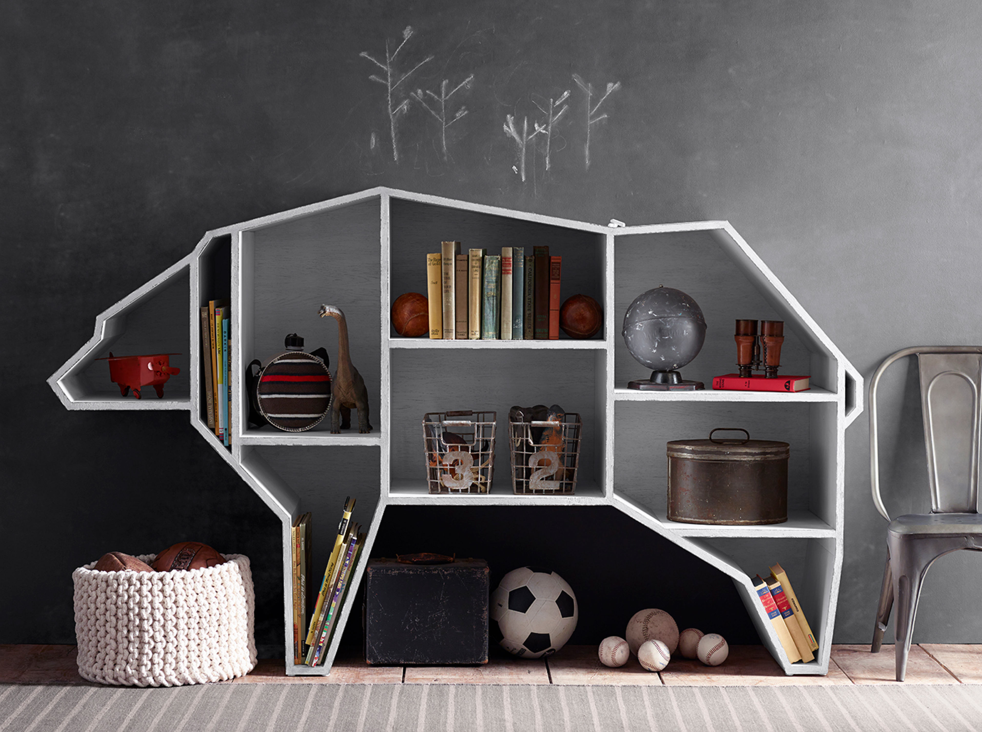 Bear-shaped children's bookshelf styled with books and toys